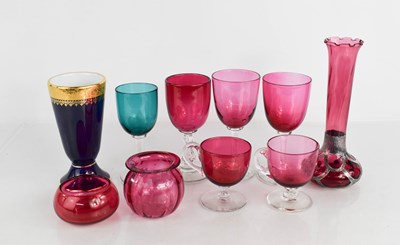 Lot 101 - A group of cranberry glass wares, including a...