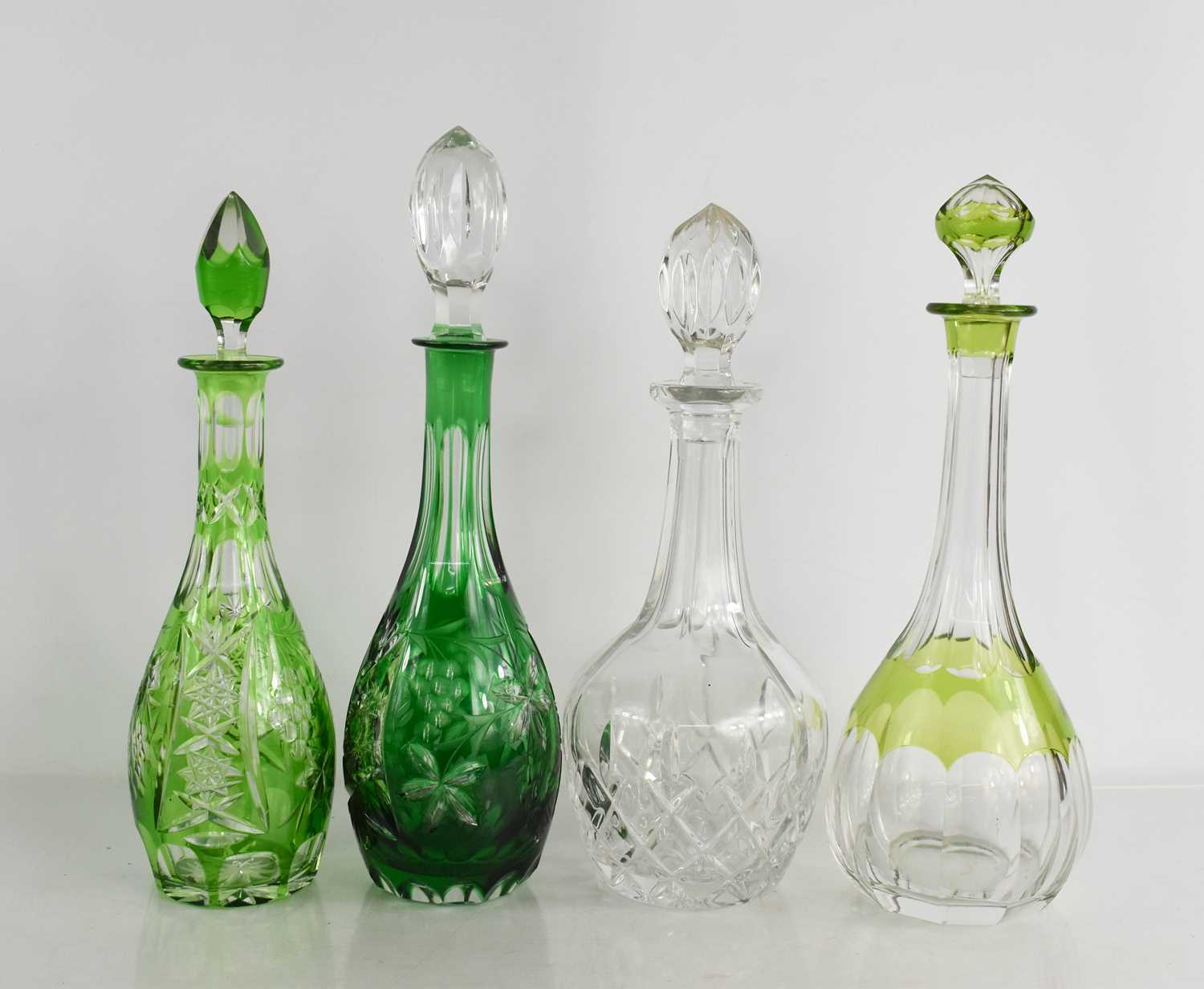 Lot 105 - Four cut glass decanters of various form,...