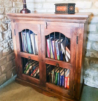 Lot 202 - A hardwood rustic cabinet, with two doors...