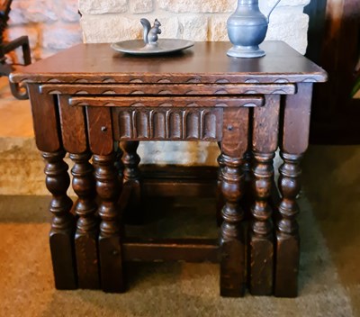 Lot 203 - A nest of oak 18th century style tables, with...