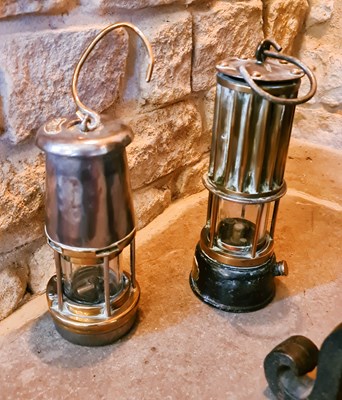 Lot 69 - Two antique brass miners lamps.