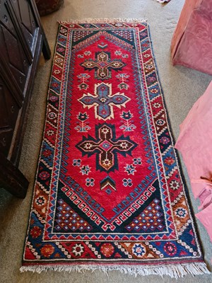 Lot 366 - An antique Middle Eastern red ground rug, with...