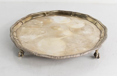 Lot 342 - A silver salver, raised on four ball and claw...