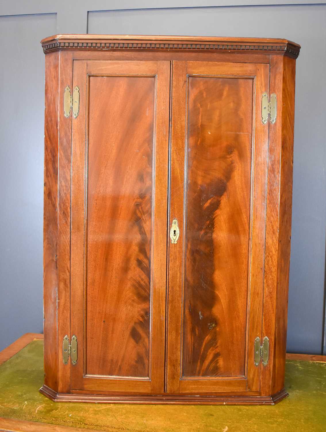 Lot 483 - A mahogany corner cupboard, with flame...