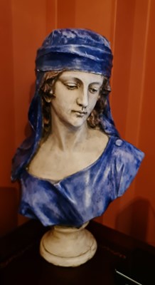 Lot 146 - A pottery bust in the form of a woman wearing...