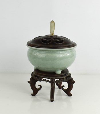 Lot 10 - A Chinese celadon glazed tripod censer,...