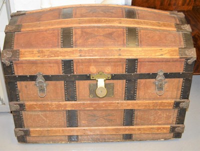 Lot 639 - An antique dome top traveling trunk clad in...