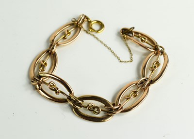 Lot 36 - A rolled rose gold oval link bracelet with...