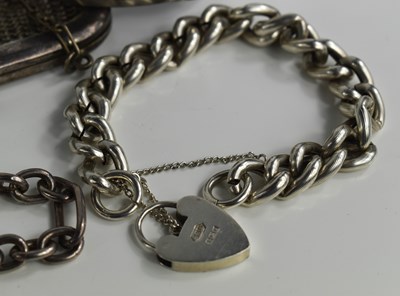 Lot 30 - A silver curb link charm bracelet, with heart...