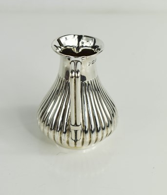 Lot 208 - A Christopher Dresser influenced silver cream...