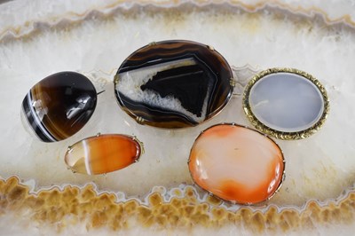 Lot 15 - A group of five agate set brooches.