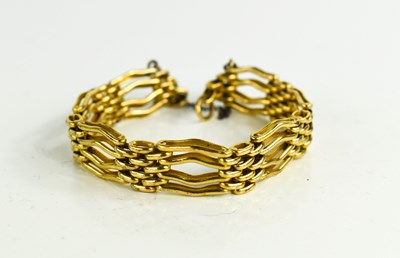 Lot 10 - A vintage gold plated wavy gate-link bracelet,...