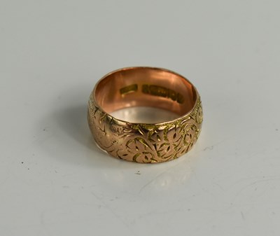 Lot 42 - A 9ct gold wedding band, foliate engraved,...