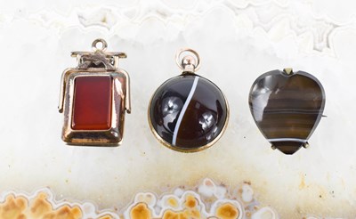 Lot 8 - A Victorian banded agate pendant, in rolled...