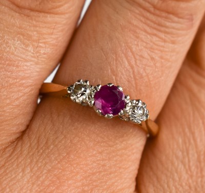 Lot 156 - An 18ct gold, diamond and ruby trilogy ring,...