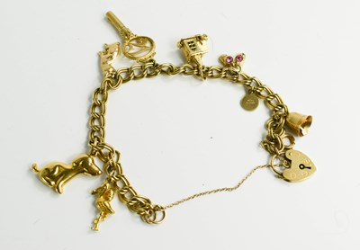 Lot 161 - A 9ct gold charm bracelet, with eight charms,...