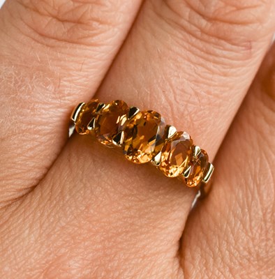 Lot 128 - A 9ct gold and citrine ring, the five oval cut...