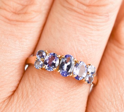 Lot 120 - A 9ct gold and tanzanite ring, with five oval...