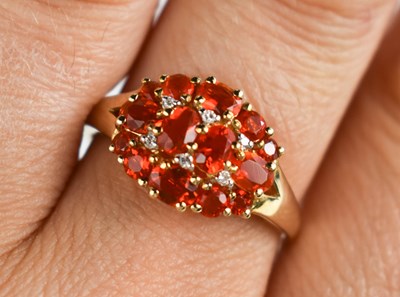 Lot 126 - A 9ct gold, fire opal and diamond cluster ring,...