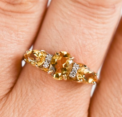 Lot 127 - A 9ct gold, citrine and diamond ring, size S,...