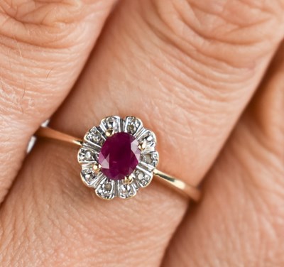 Lot 124 - A 9ct gold, ruby and diamond ring, the central...