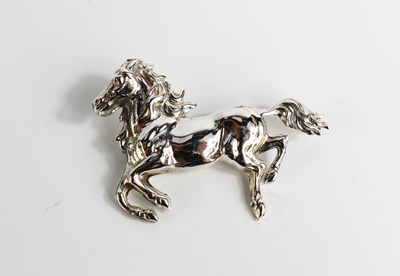Lot 87 - A silver brooch in the form of a galloping...