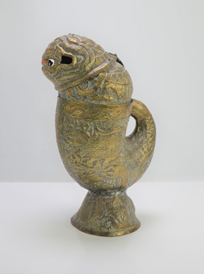 Lot 5 - A late 19th century Indian embossed brass jug...