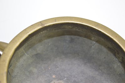 Lot 6 - A Chinese bronze censer with twin handles and...