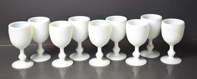 Lot 52 - A set of nine white slag glass goblets.
