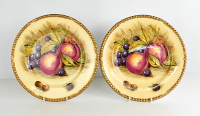 Lot 78 - A pair of Aynsley plates by D Jones, painted...