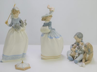Lot 81 - Three Lladro figurines, child with puppies and...
