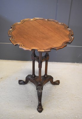 Lot 386 - A 19th century mahogany pie crust occasional...