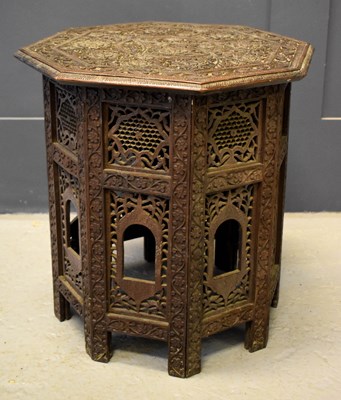 Lot 365 - A small Indian carved table with folding base...