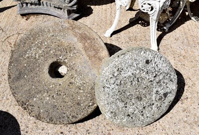 Lot 474 - A stone mill wheel and a granite saddle stone.