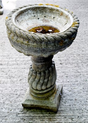 Lot 472 - A reconstituted stone birdbath with writhen...