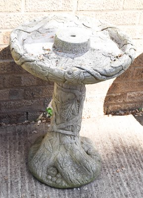 Lot 471 - A reconstituted stone garden birdbath with ivy...