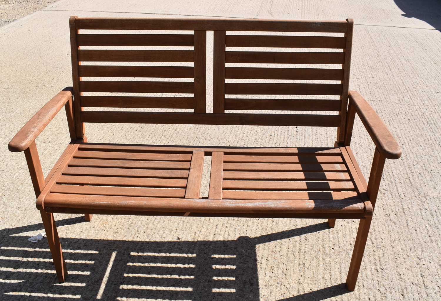 Lot 455 - A small teak garden bench.