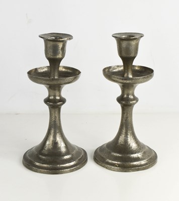 Lot 140 - A pair of pewter candlesticks, with a hammered...