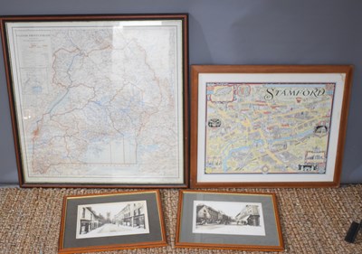 Lot 535 - A framed and glazed map of Uganda together...