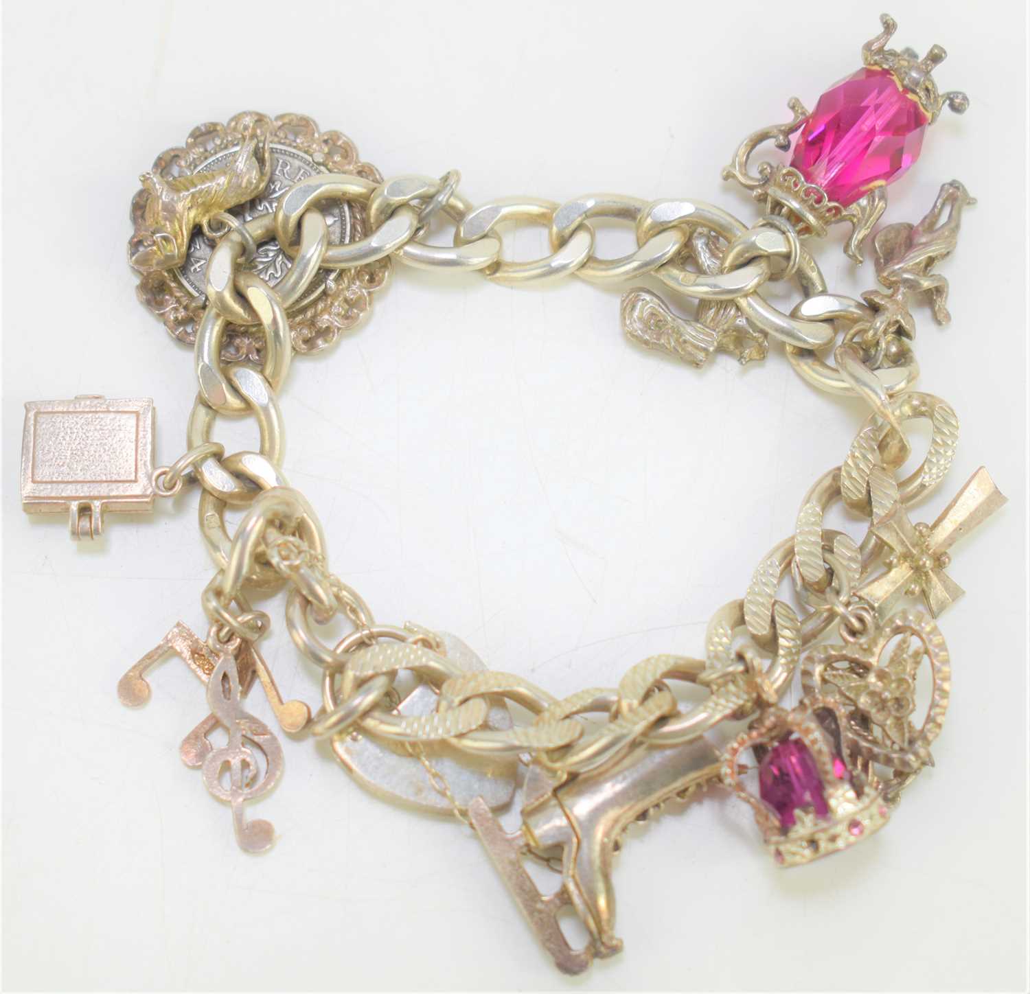 Lot 185 - A sterling silver charm bracelet with fourteen...