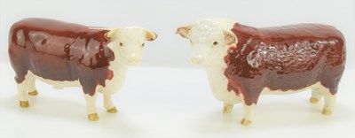 Lot 348 - A Beswick Hereford cow and bull, 11.5cm high.