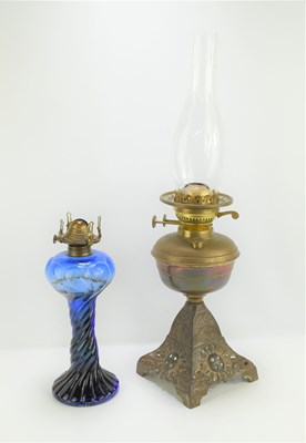 Lot 239 - A late 19th century oil lamp with cranberry...