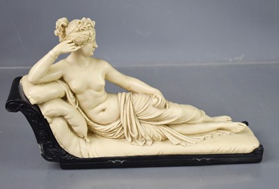 Lot 241 - A resin figure of a classical lady laid upon...