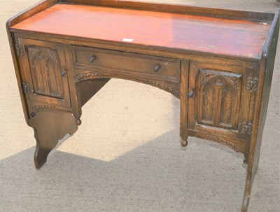 Lot 633 - An oak effect desk, two cupboards with central...