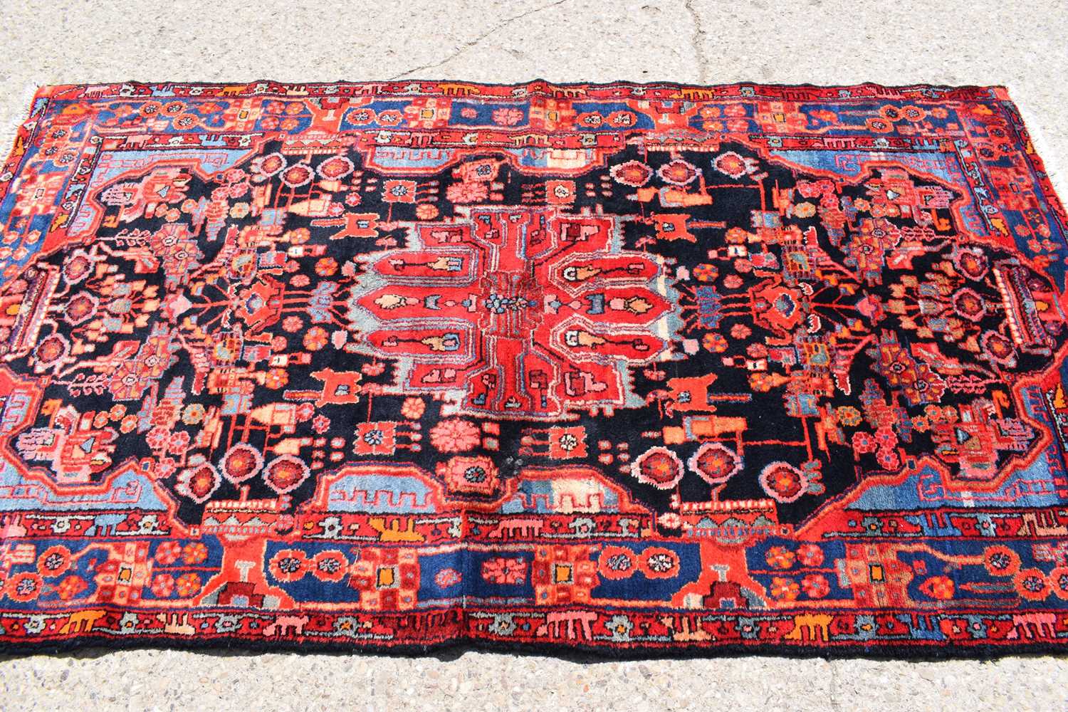 Lot 434 - A Middle Eastern red ground wool rug, hand...
