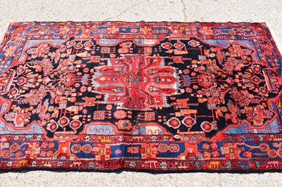 Lot 616 - A Middle Eastern red ground wool rug, hand...