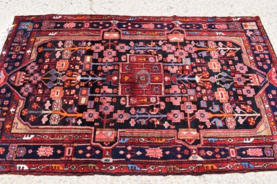 Lot 617 - A Middle Eastern red ground wool rug, the...