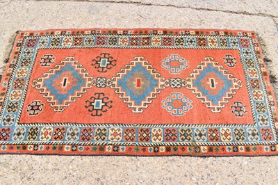 Lot 611 - A Persian wool rug with orange ground, triple...