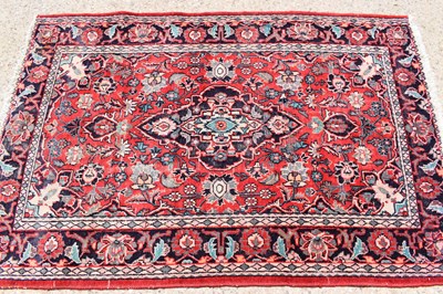 Lot 612 - A Persian wool rug with red ground, the...