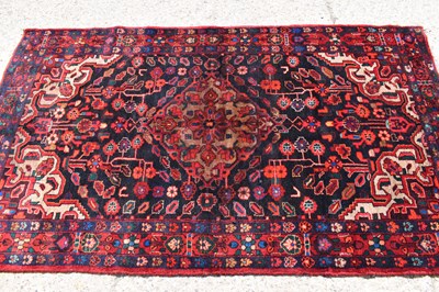 Lot 618 - A middle Eastern wool rug, deep red and blue...